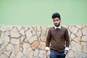 Portrait of young stylish indian man model pose in street. photo