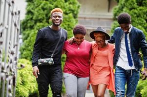 Four african friends having fun outdoors. Two black girls with guys. photo