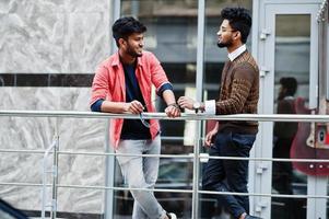 Two young stylish indian man frieds model posing in street. photo
