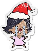 distressed sticker cartoon of a woman crying wearing santa hat vector