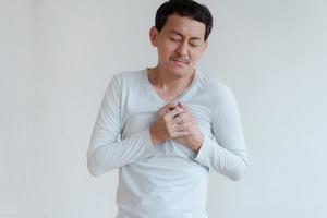 a man touching his heart, with red highlight of heart attack, and others heart disease concept, Heart attack symptom photo