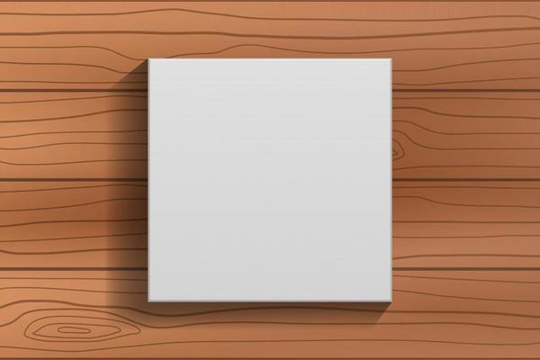 White blank canvas frame on brown wooden floor background