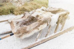 close up of a wooden deer sledge covered with fur lining photo