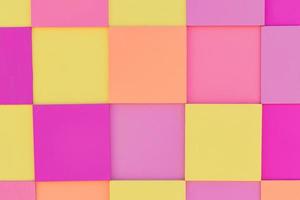 Multicolored wooden panel in pink, yellow and orange pastel colors for background photo