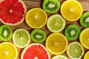 frame with slice of oranges, lemons, kiwi, grapefruit pattern isolated on white background. photo