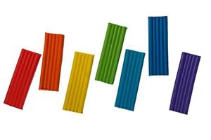 Rainbow colors of modeling clay. Multicolored plasticine bars isolated on white background. photo