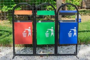 Colorful trash bins for sorting garbage in the park. Waste separate collection and recycling concept photo