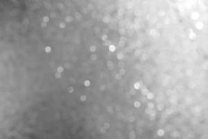 Bokeh abstract texture. Beautiful christmas background in silver colors. Defocused photo