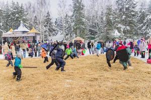 Moscow Region, Russia, 2018 - Celebration of Russian Shrovetide. Children playing russian giants on the field photo