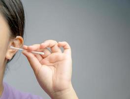 Asian woman cleaning her ears photo