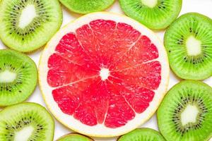 citrus slice - kiwi, oranges and grapefruits on white background. Fruits backdrop photo