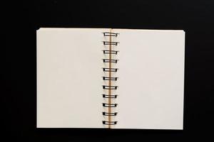 Design concept - Top view of empty kraft notebook on black background. mock up. photo