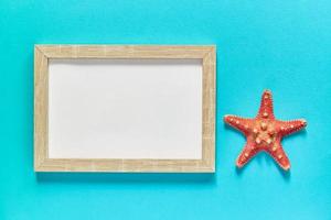 mockup photo frame with a star fish on blue background