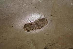 footprint on raw concrete layer photo