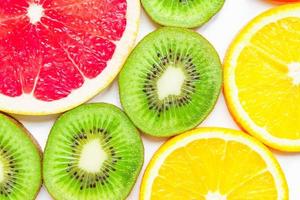 close up of citrus slice, kiwi, oranges and grapefruits isolated on white background. Fruits backdrop