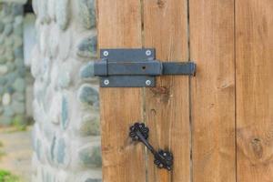 close up of wooden door with metal latch lock photo