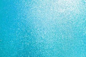 Sparkled glitter abstract texture. Beautiful christmas background in light blue colors. Defocused photo