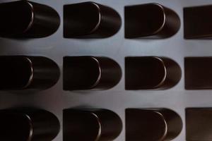 empty box of chocolate shapes. Abstract texture background photo