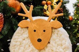 Street Christmas decoration. Christmas deer made of wood and wool. Christmas celebration concept, holiday mood photo