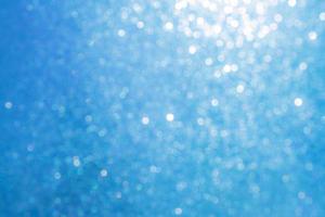 Bokeh abstract texture. Beautiful christmas background in light blue colors. Defocused photo