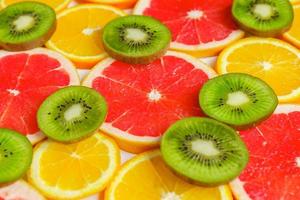 citrus slice, kiwi, oranges and grapefruits on white background. Fruits backdrop photo