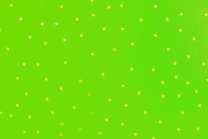 abstract green background with scattered golden stars photo