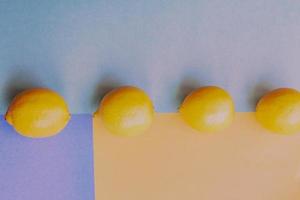 three lemons on colorful orange, blue and green background, retro toned photo