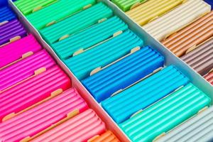 Rainbow colors of modeling clay. Multicolored plasticine bars ina box, background texture photo