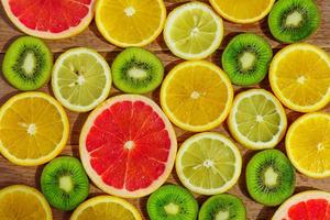 frame with slice of oranges, lemons, kiwi, grapefruit pattern isolated on white background. photo