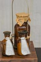 vintage medicine brown glass bottles on the table. At the Pharmacy shop photo