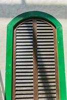 closw up of a window with wooden shutters on white wall photo