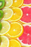 citrus slices - kiwi, oranges and grapefruits isolated on white background. Fruits backdrop photo
