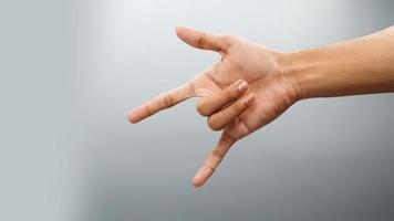 Rock on gesture symbol on white background photo