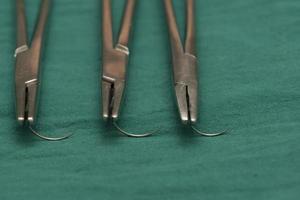 Three needle holders and empty needles photo