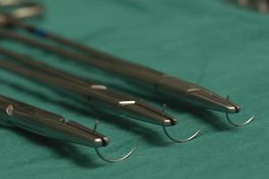 Three needle holders and empty needles photo