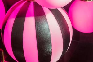 plenty pink lanterns in ball shape. Party decoration photo