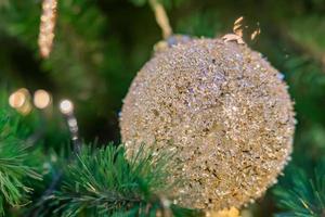 Christmas and New Year holidays background.  Christmas tree decorated with golden balls. Celebration concept photo