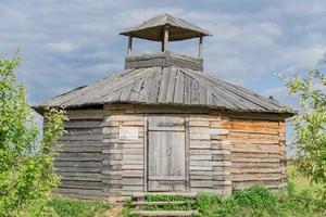 wooden house at the edge of the forest under dramatic sky photo