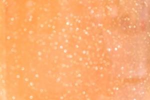 Bokeh abstract texture. Beautiful christmas background in orange colors. Defocused photo