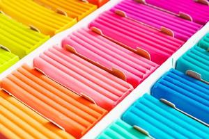 Rainbow colors of modeling clay. Multicolored plasticine bars ina box, background texture photo