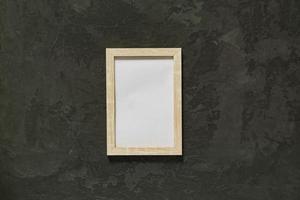 Wooden photo frame on black background. Minimal flat lay with kopy space.