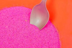 colored pink sand in plastic bowl. Workshop for making sand pictures for kids photo