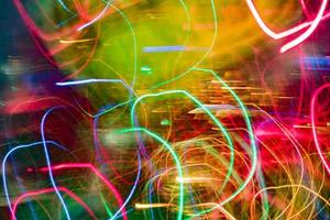 Neon multicolor glowing lines. Defocused gleam in motion. photo
