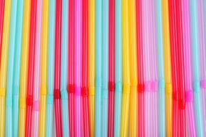 blue, pink and yellow straws for cocktails and other drinks isolated on white background photo