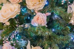 close up of christmas tree decorated with tender pink flower. photo