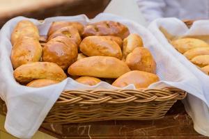 hommade pastry  delisious stuffed pies in whicker basket. photo