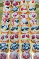 Pastry shop display window with variety of mini desserts and cakes, candy bar, selective focus photo