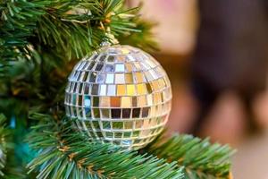 Christmas and New Year holidays background.  Christmas tree decorated with silver disco ball. Celebration concept photo