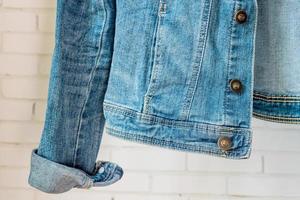 bottom of Blue denim woman jacket. Clothes fragment photo