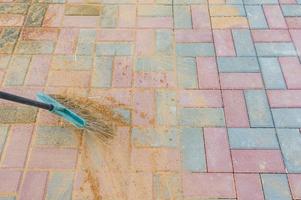 Broom swipes paved walkway grouted with sand photo